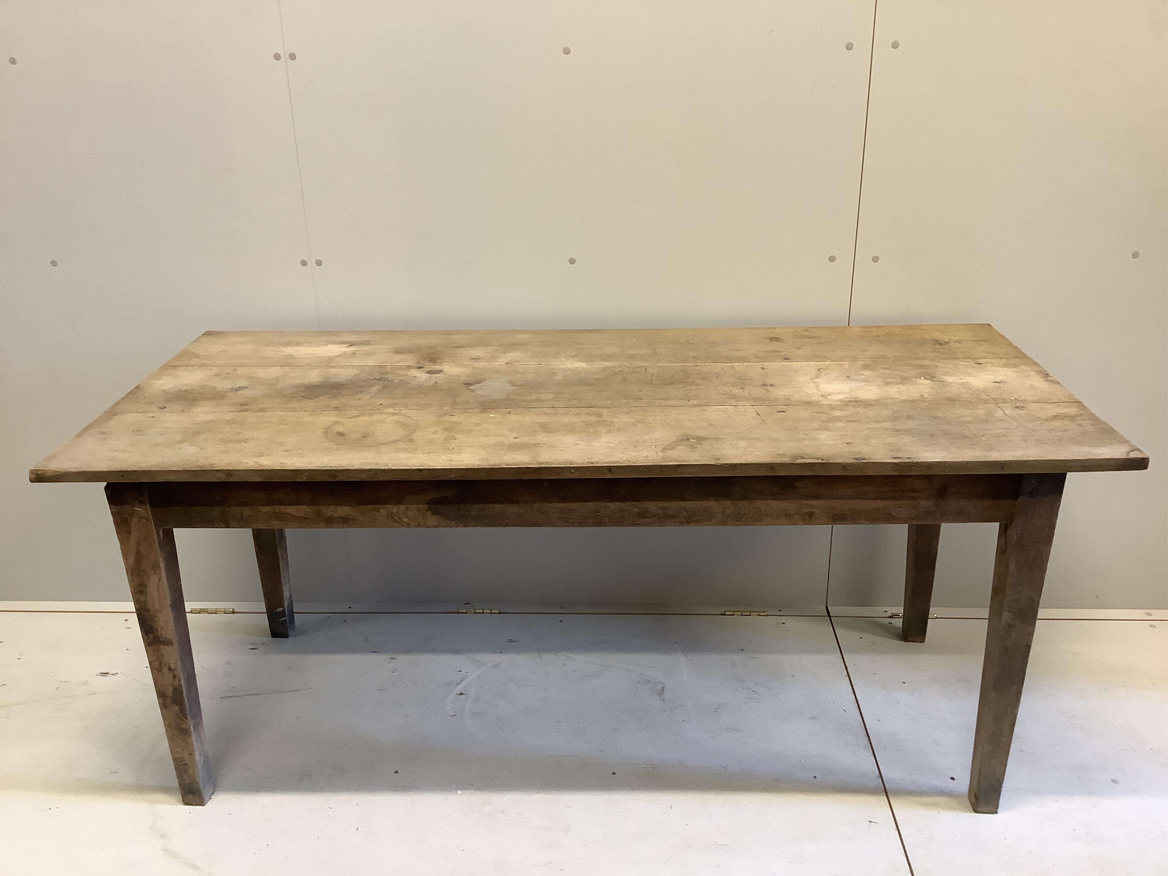 A 19th century French oak and walnut kitchen table, width 175cm, depth 78cm, height 76cm. Condition - faded and stained but essentially solid